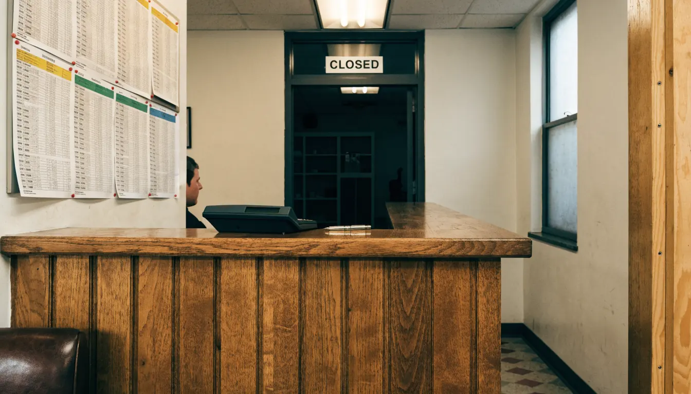Australian wagering shop counter with racing forms and closed adjacent door.